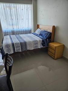 a small bed in a room with a window at PEPE´S HOUSE in Puno