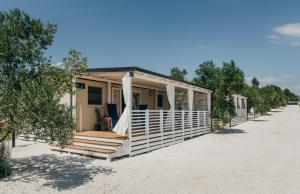 uma casa na praia com um alpendre em San Antonio mobile homes em Biograd na Moru