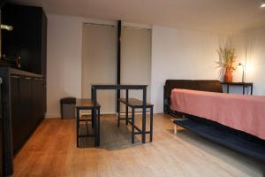 Rúm í herbergi á Appartement avec une chambre