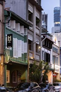 a street with cars parked in front of buildings at NEWLY REFURBISHED - Heritage Collection on Ann Siang in Singapore