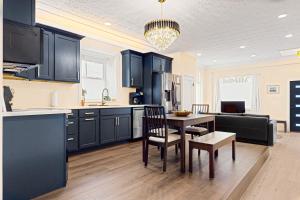 a kitchen with black cabinets and a table and chairs at Black Pearl in Rutland