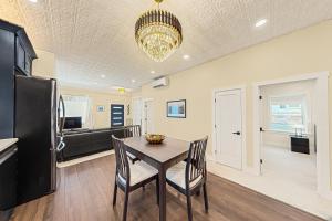 a kitchen and dining room with a table and a refrigerator at Black Pearl in Rutland