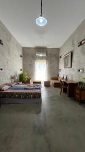 a large room with a bed and a window at Bali Bobo Hostel in Jimbaran