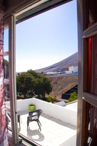 a view from the balcony of a house with a table and chairs at hotel rural GA7COLORES only adult in Montaña Blanca