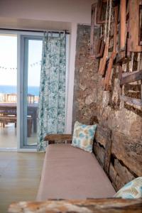 a living room with a couch and a stone wall at Kumekucha Ocean View in Dar es Salaam