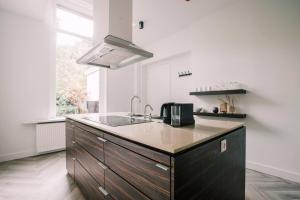 a kitchen with a sink and a counter top at Luxious Apartment Wilhelmina in Tilburg