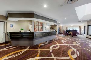 an office lobby with a reception desk and a table at Best Western Plus Otonabee Inn in Peterborough