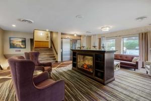 a living room with a fireplace and couches at Best Western Plus Otonabee Inn in Peterborough