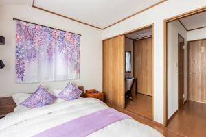 A bed or beds in a room at Charming New Home Launch: Direct access to Narita & Haneda Airports, Shinjuku, and Disneyland; Close to Asakusa & Akihabara!