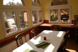 a dining room with a table and some windows at family & friends in Wernigerode