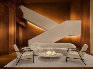 a living room with a couch and two chairs and a table at The Tokyo EDITION, Ginza in Tokyo