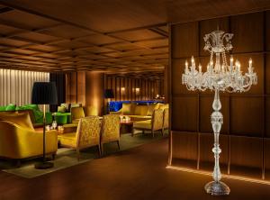 a hotel lobby with a chandelier and chairs at The Tokyo EDITION, Ginza in Tokyo