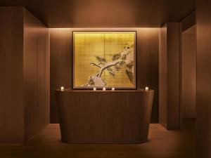 a room with a painting on the wall with candles at The Tokyo EDITION, Ginza in Tokyo