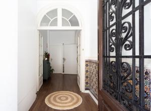 a hallway with an ornate door and a rug at Divino Hotel Boutique in Sitges