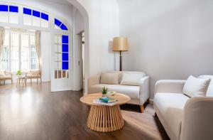 a living room with a couch and a table at Divino Hotel Boutique in Sitges