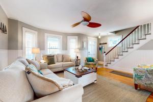 a living room with a couch and a ceiling fan at Gloucester Coastal Gem in Gloucester