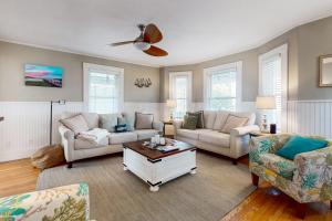 a living room with two couches and a coffee table at Gloucester Coastal Gem in Gloucester