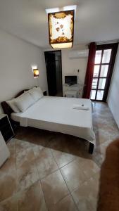 a bedroom with a large white bed in a room at Pousada Beijos y Abraços in Natal