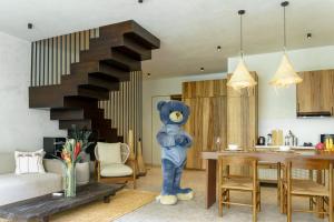 um grande urso de peluche azul parado numa sala de estar em Sunny Cuddles em Canggu