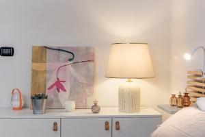 a bedroom with a lamp on a dresser at Nel cuore del rione del Drago in Pistoia