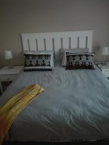 a large bed with two pillows on top of it at K Partners' Boutique Hotel & Spa in Langebaan