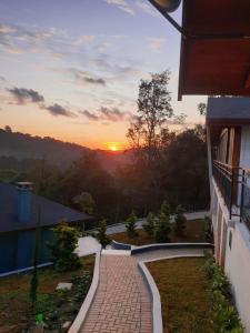 un tramonto dal balcone di una casa con passerella in mattoni di POUSADA GRESSONEY MOUNTAIN a Monte Verde