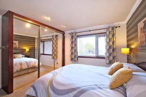 1 dormitorio con 2 camas y ventana grande en The Jays Guest House, en Aberdeen