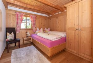 a bedroom with a bed in a wooden cabin at Hotel Zimmerbräu in St. Wolfgang