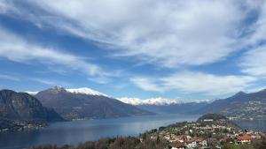 a view of a lake with snow capped mountains at Hotel Il Perlo in Bellagio