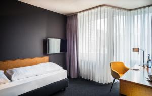 Una cama o camas en una habitación de Best Western Hotel Kaiserslautern