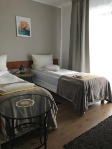 a bedroom with a bed and a table and a window at Tannenhof in Semmering