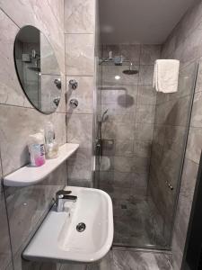 a bathroom with a sink and a shower at Hotel Dietrichsdorfer Hof in Kiel