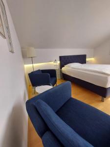 a hotel room with a bed and a couch at Erlebnishaus Spiess in Feldkirchen in Kärnten