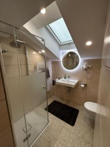 a bathroom with a glass shower and a sink at Erlebnishaus Spiess in Feldkirchen in Kärnten