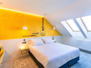 Кровать или кровати в номере Ibis Styles Sibiu Arsenal