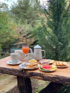 un tavolo in legno con cibo e bevande di The Patagonian Lodge a Coihaique