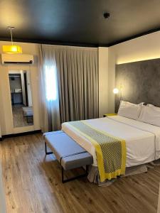 een slaapkamer met een groot bed en een raam bij Oasis Tower Hotel in Ribeirão Preto