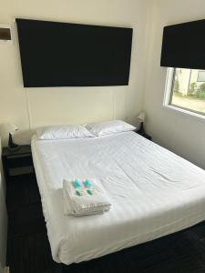 a bed with two plastic containers on top of it at Batemans Bay Holiday Park & Hostel in Batemans Bay