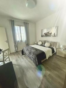 a bedroom with a bed and a large window at Sweet Home FCO Airport Roma in Fiumicino