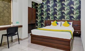 a bedroom with a bed and a chair in it at Itsy Hotels NRM Residency in Mysore