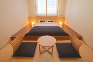 A bed or beds in a room at Ishigakijima Hotel Cucule