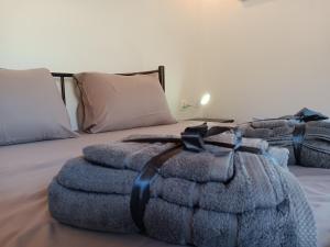 a bedroom with two beds with pillows and a blanket at Tolis Rooms in Himare