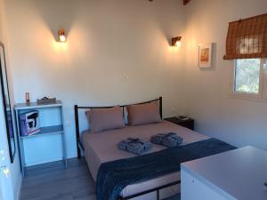 a bedroom with a bed with two pillows on it at Tolis Rooms in Himare