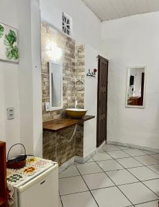 a bathroom with a sink and a counter with a sink at Pousada Cafe e Mar Jeri in Jericoacoara