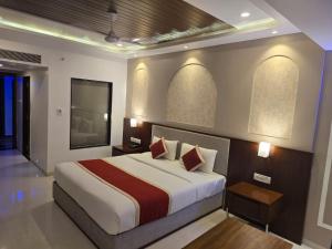 a bedroom with a large bed and two windows at KAMAT'S DAFFODIL RESORT GOA in Pilerne