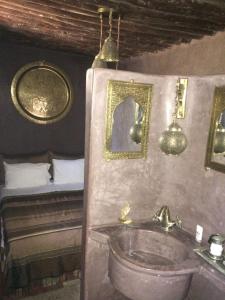 een badkamer met een wastafel en een bed bij Riad Marhaba in Rabat