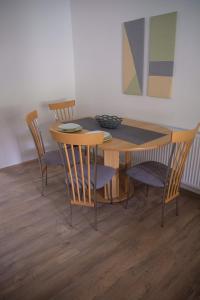 mesa de comedor con sillas y mesa de madera en Kincses Vendégház, en Senta