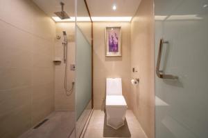 a bathroom with a toilet and a shower at Guangzhou Baiyun Airport Yunzhi Hotel near Terminal One - Complimentary Shuttle Bus between hotel to Canton Fair Complex during Canton Fair in Guangzhou