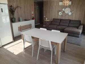 uma mesa e cadeiras numa sala de estar com um sofá em 7stars Apartment em Faro