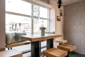 a dining room with a table and a window at Pension Padre in Ostrava